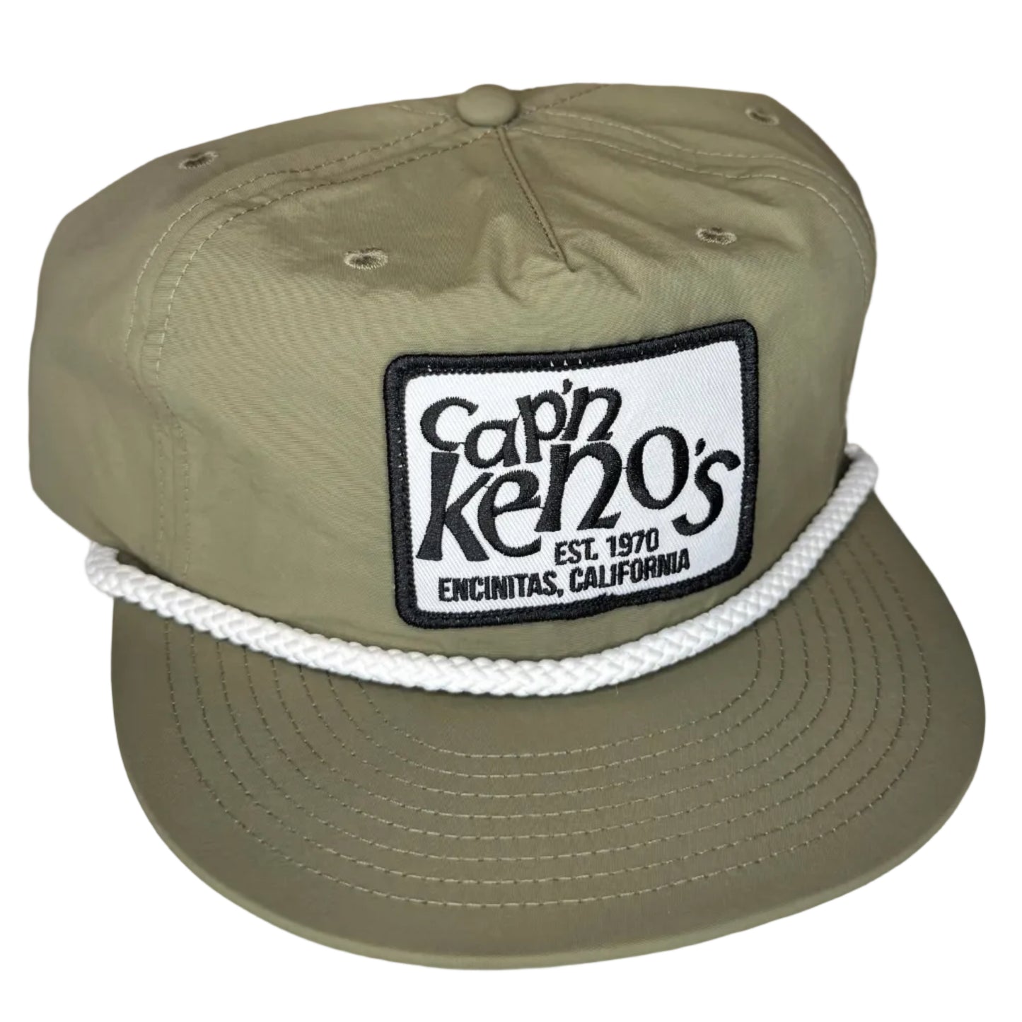 Green cap with a patch on a white surface