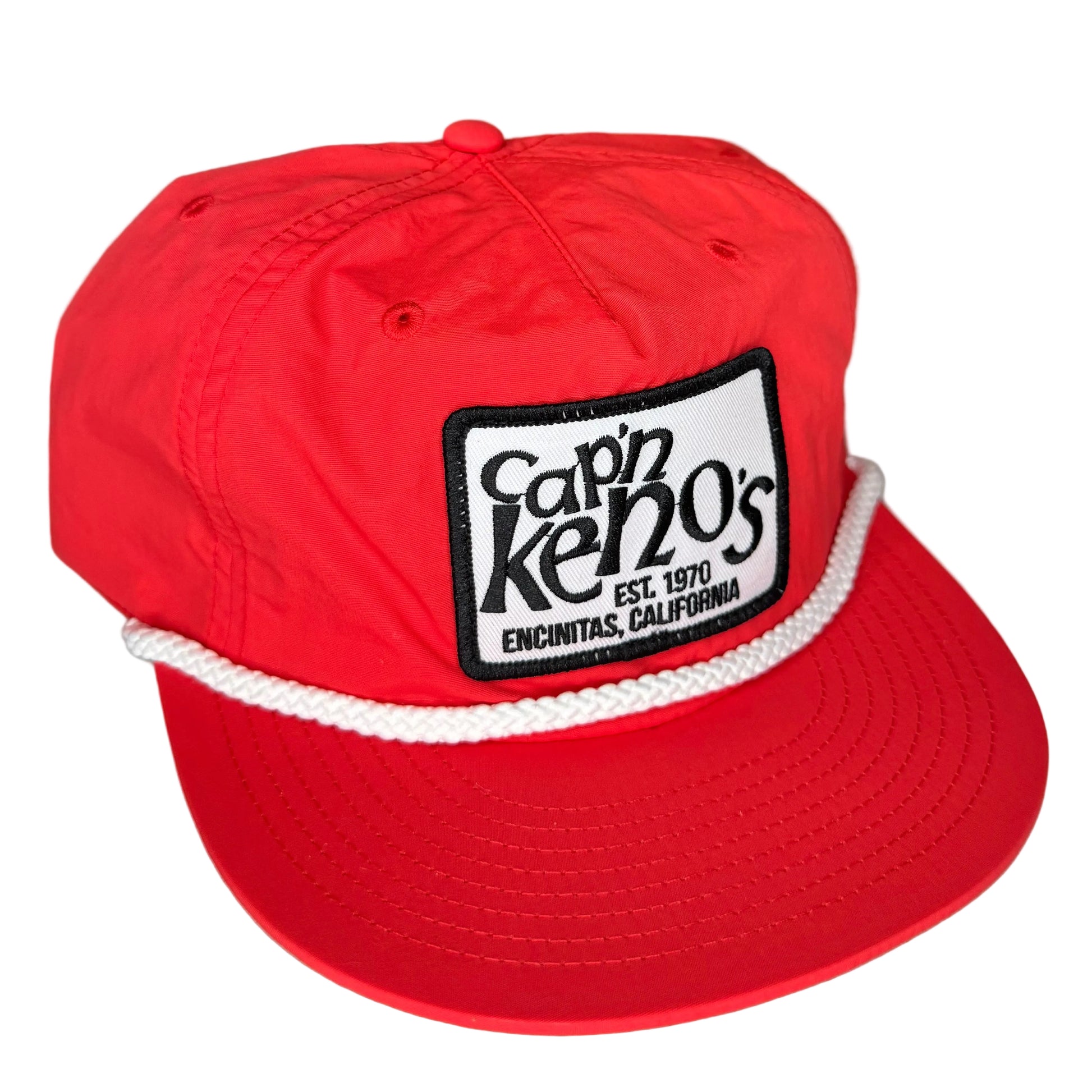 Red cap with a logo on a white surface